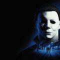 Official Halloween: The Game key art of Michael Myers looming over Haddonfield